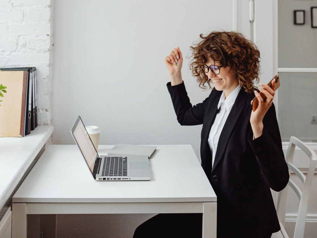 woman-excited-on-laptop Reducing stress by finding the right HOA Management Company