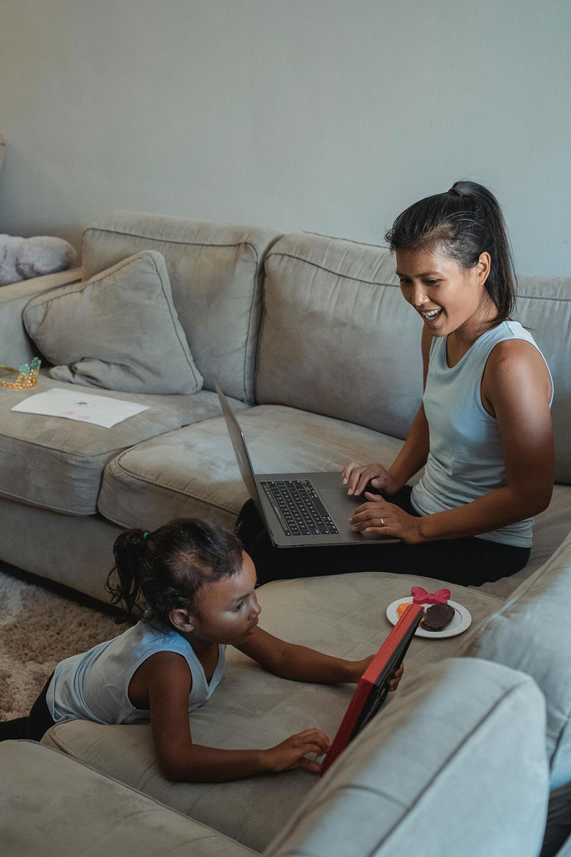HOA Board member working on reporting while their kids play near by