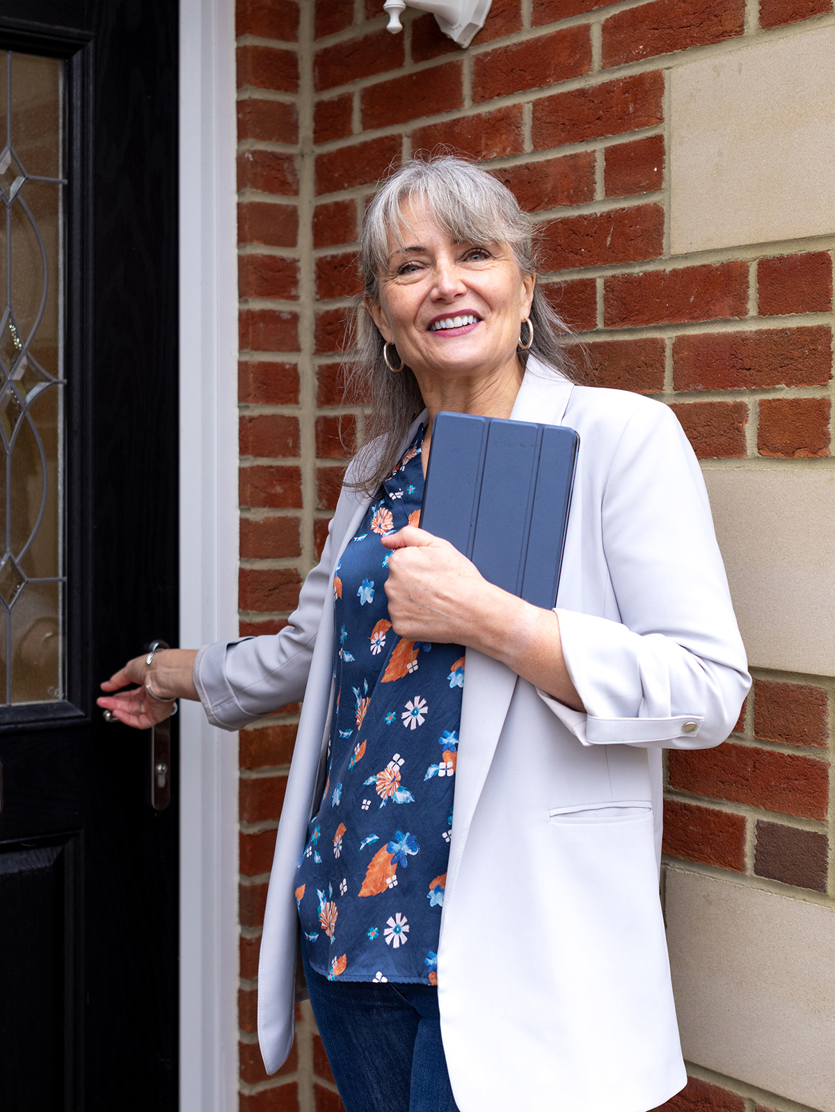 HOA Board member happily greeting community member outside of their townhome