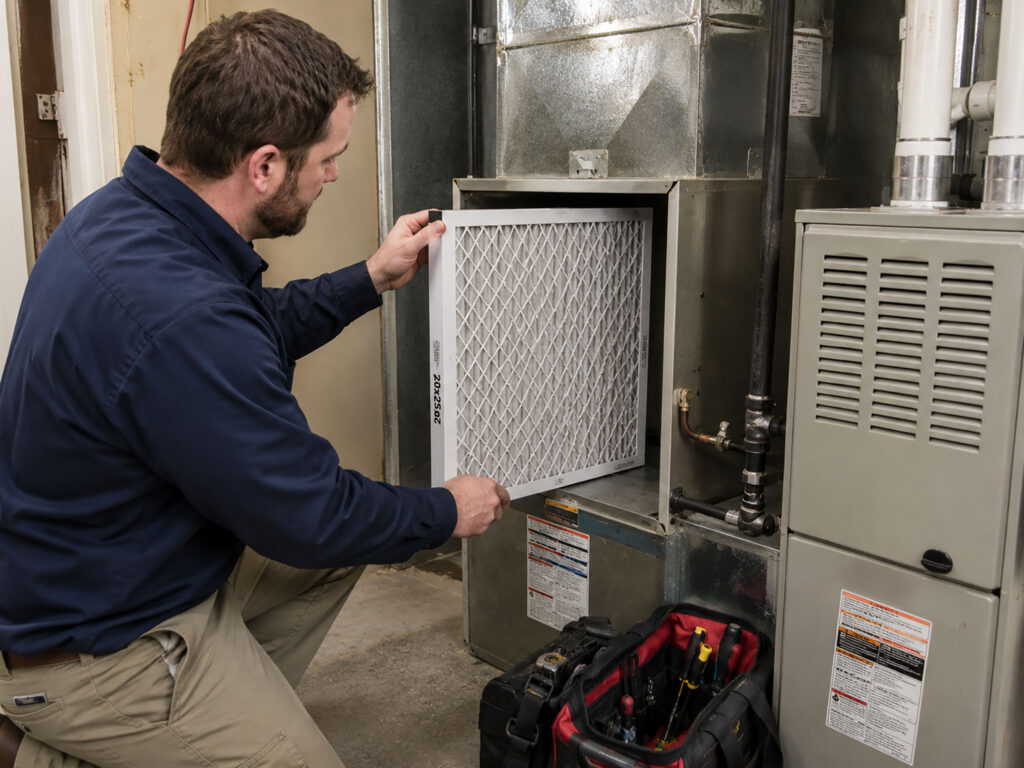 Utility Room Home Maintenance Service - changing out the furnace filter.