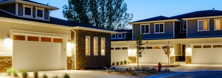 Well-lit townhome walkway at dusk after an HOA exterior lighting checklist review